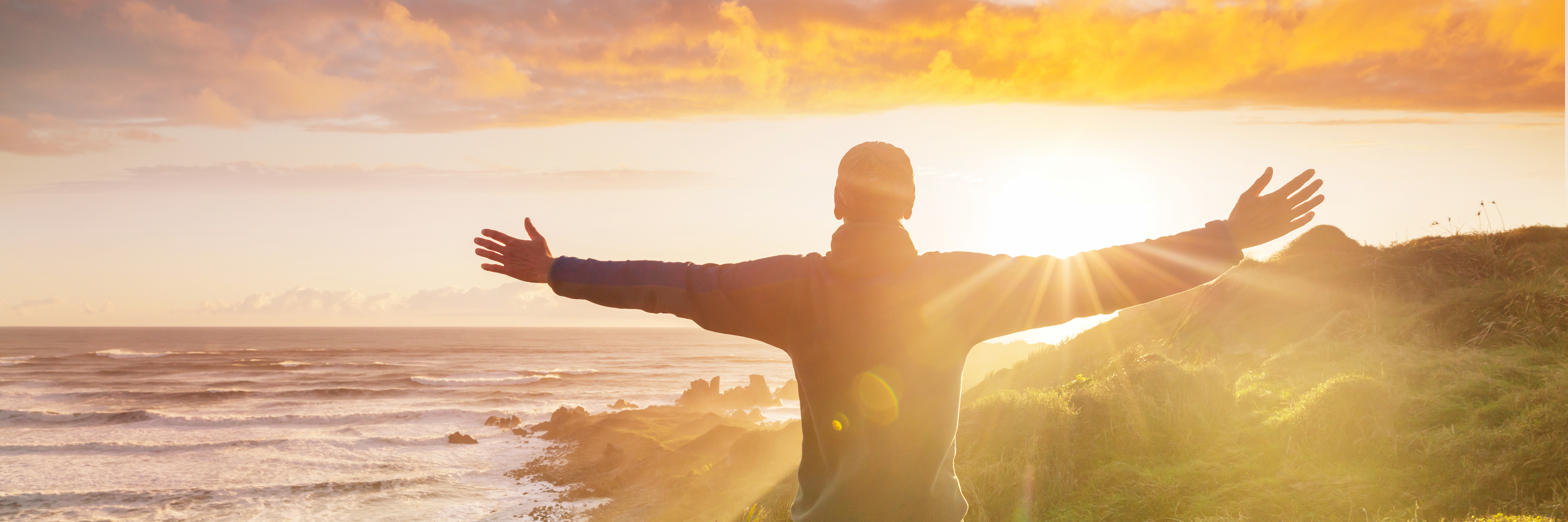 Man-open-arms-at-sunset